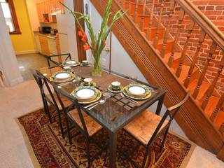 Dining area b/t kitchen and living area showcases Lovely detailed woodworking in the staircase serve