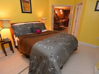 Spacious  rear bedroom has a queen-size bed and luxurious linens